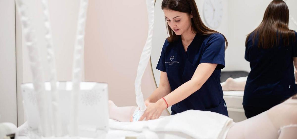 A woman receiving an endermologie treatment for body contouring and skin toning.