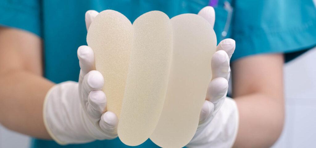 A person showcasing breast augmentation results with a focus on enhanced appearance.