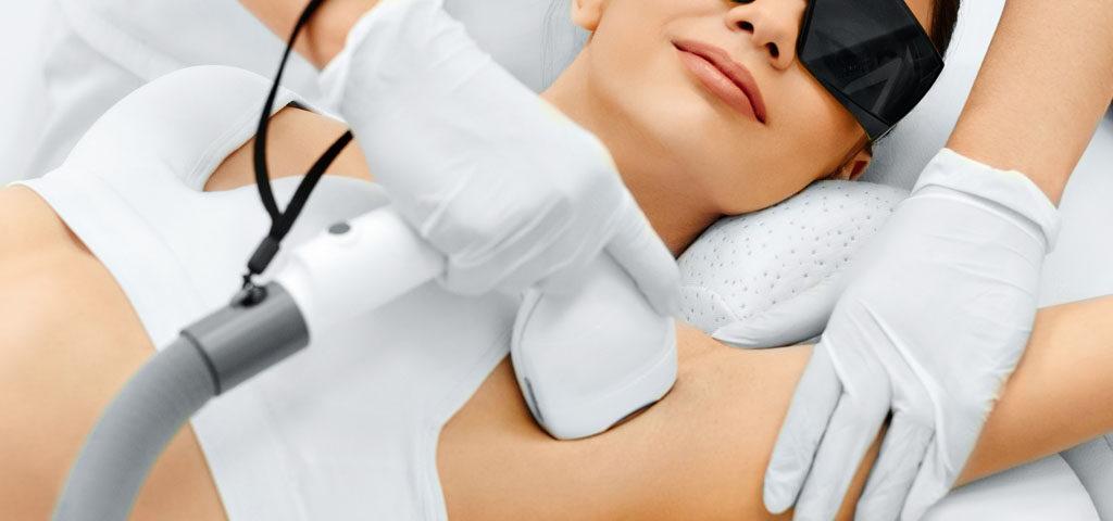 Laser hair removal treatment being performed on skin using a handheld laser device.
