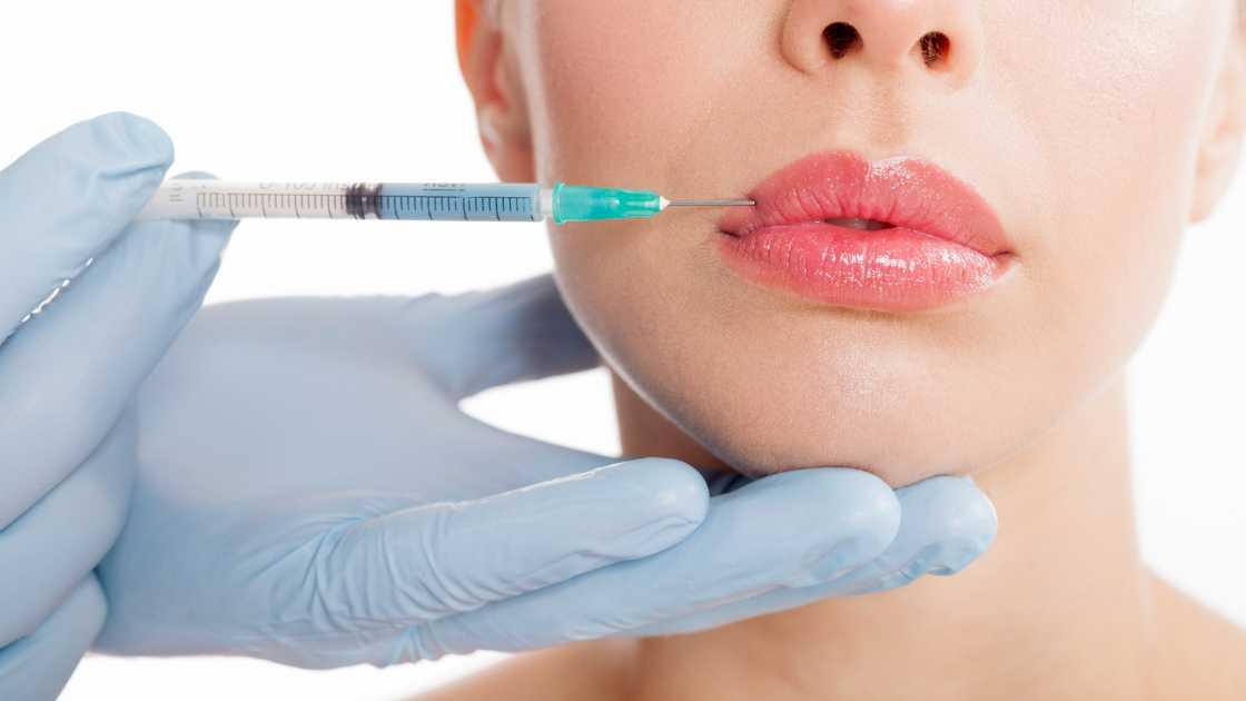 A close-up view of lip injection procedure showing before and after results.